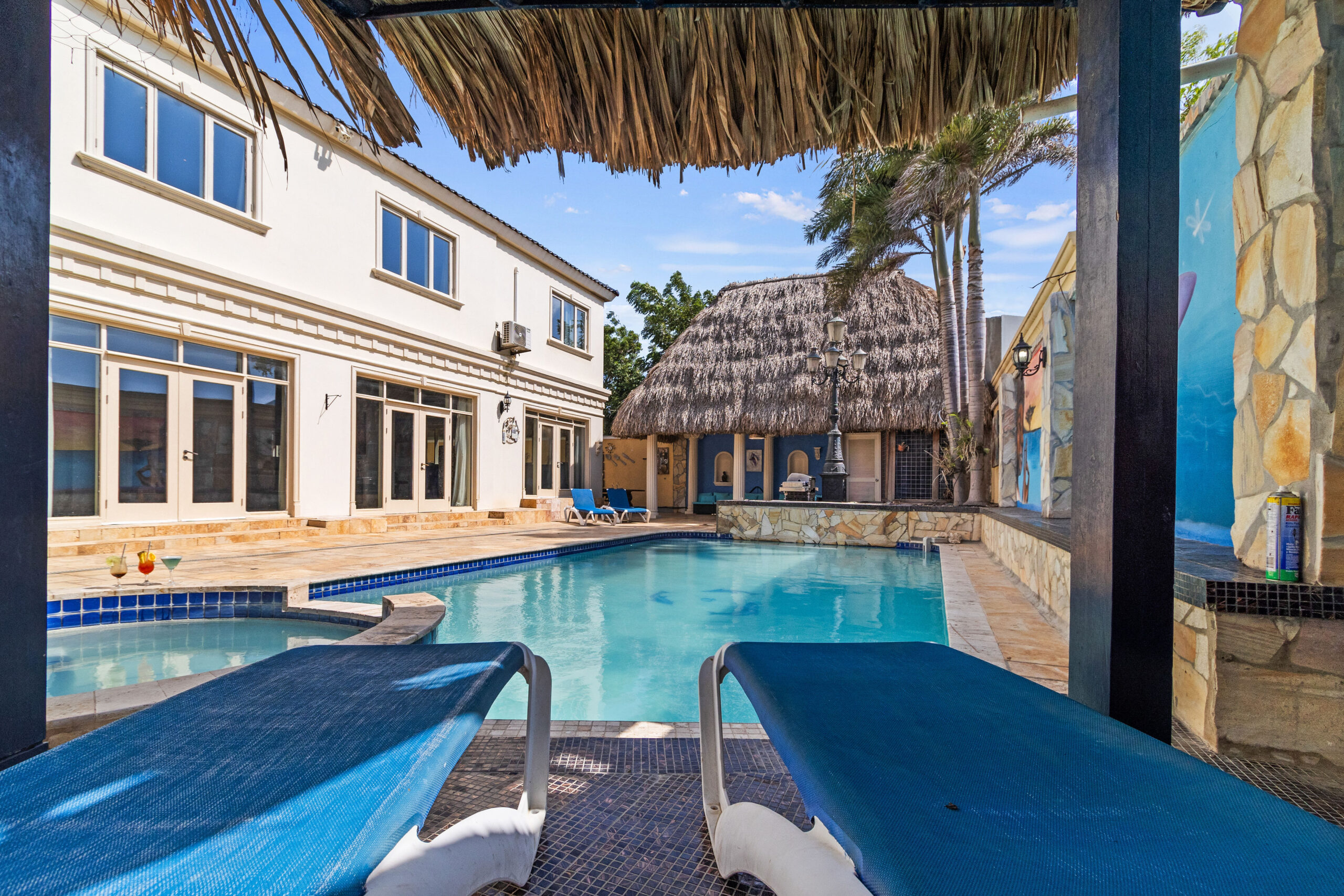 Inviting pool area at La Casa Piu Bella with tropical landscaping.